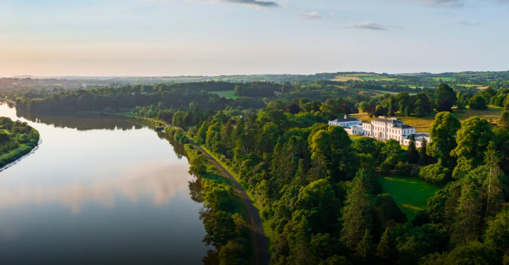 Luxurious riverside hotel amidst lush greenery and scenic landscapes, offering a tranquil escape with stunning river views.