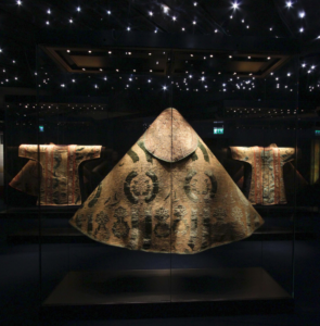 Ornate kimonos displayed under ambient lighting, creating a serene and cultural hotel gallery experience.