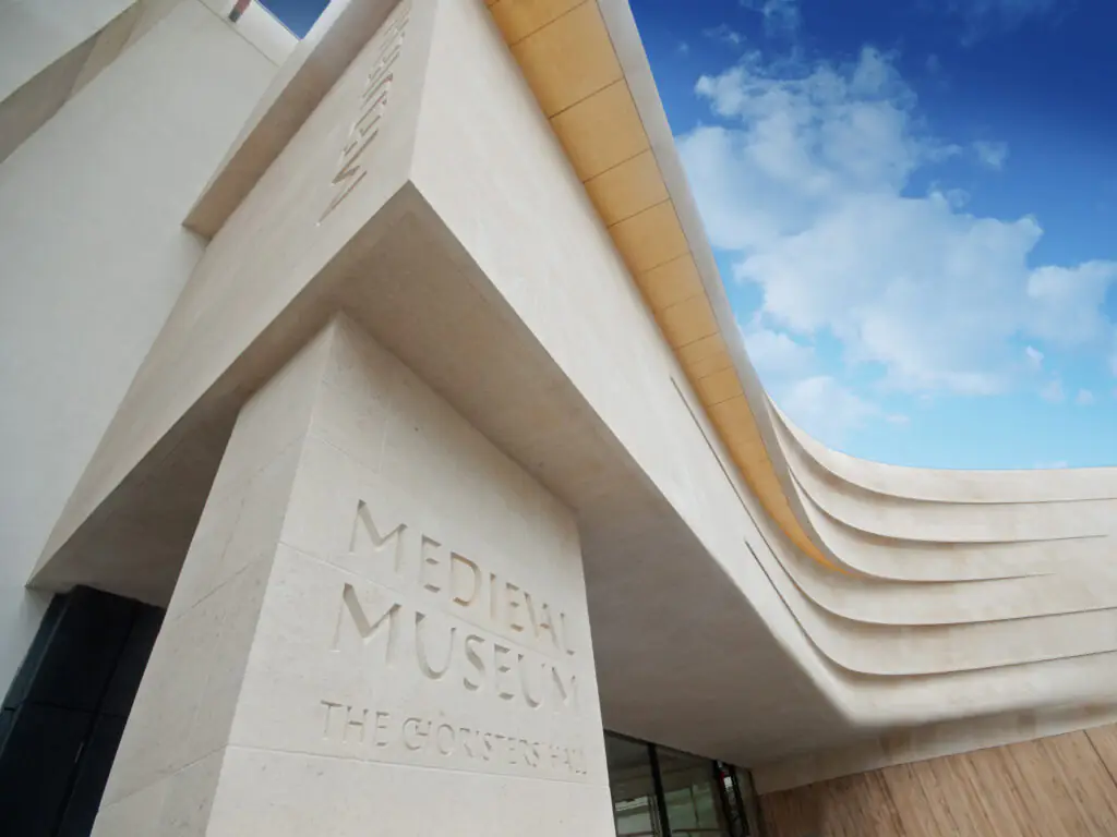 Medieval Museum Stunning architecture of the Medieval Museum, featuring sleek curves and modern design under a vibrant blue sky.