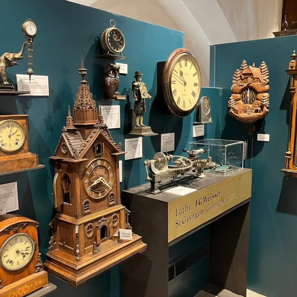 Museum of Time Discover a stunning collection of vintage clocks and timepieces displayed on a teal wall in our elegant hotel lobby.